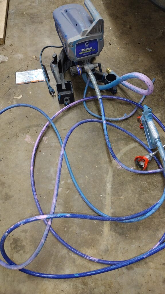 Graco Paint Sprayer with the extension located in the garage.