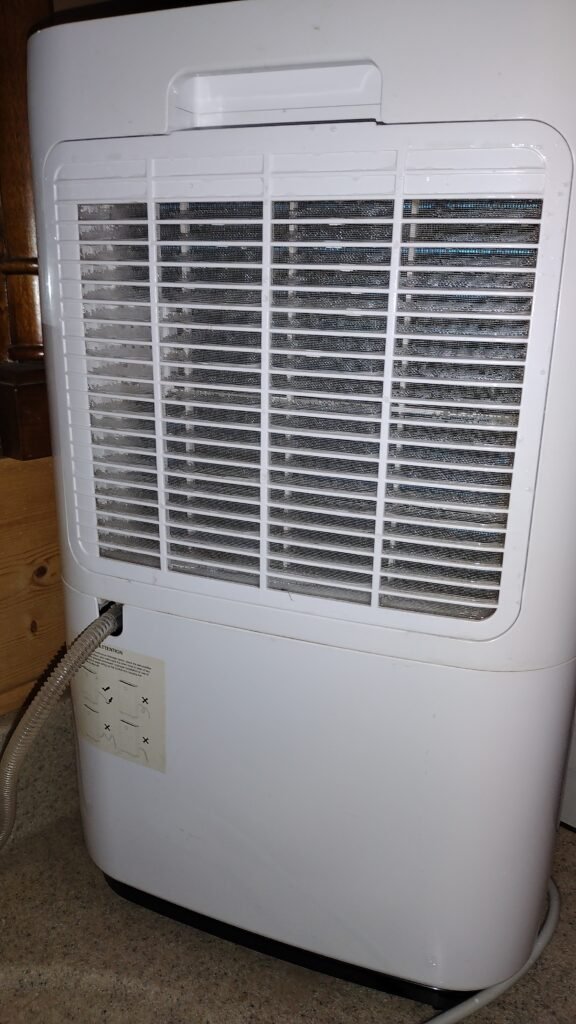 The back of the dehumidifier, located in the basement bathroom that has no exhaust.